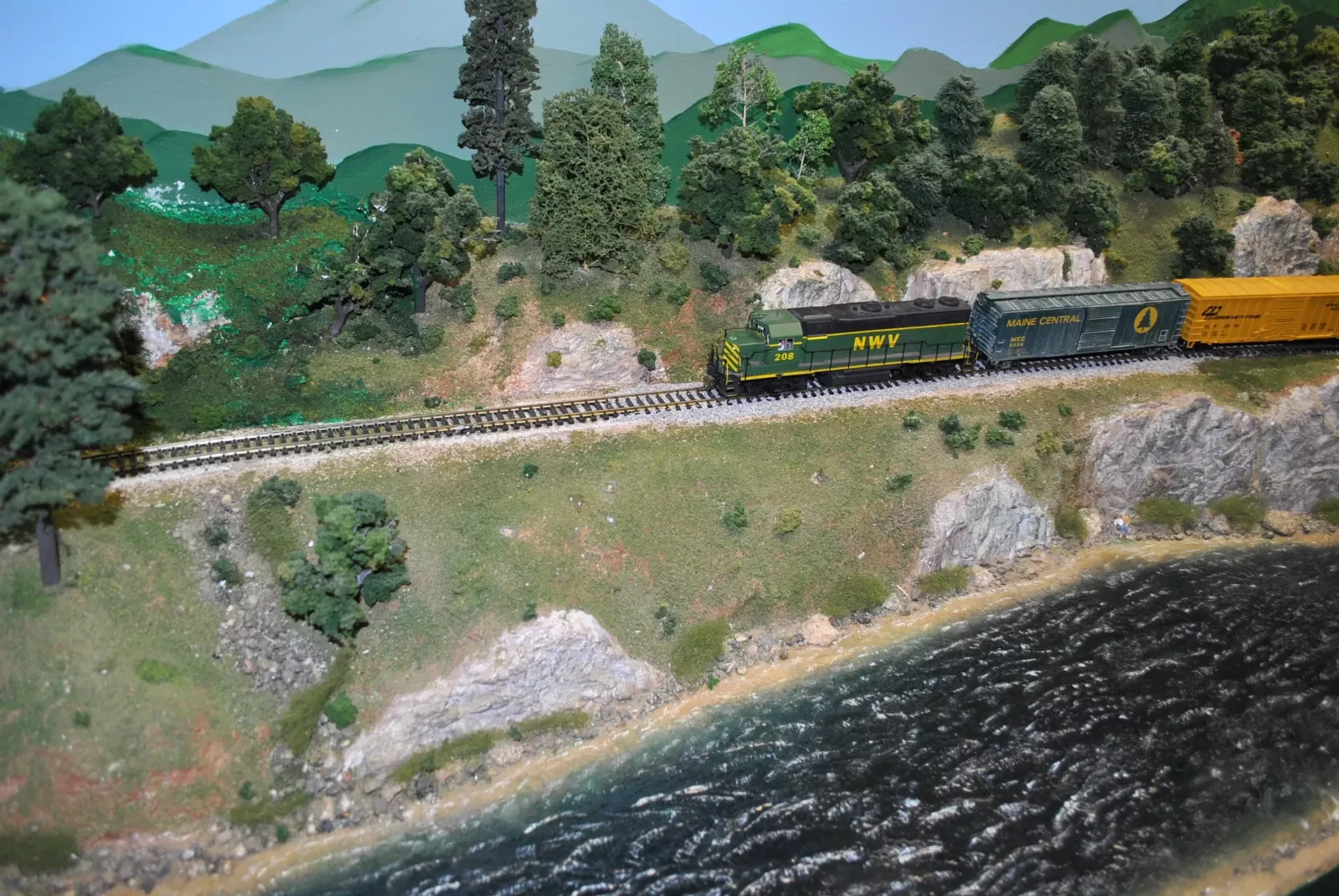 The NWV Railroad's "Local 501" rolls along the river bank on the Northwestern Vermont Model Railroad Association's HO-scale layout in Essex Junction.