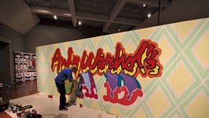 Ben Eine painting the installation "Andy Warhol's BAD"