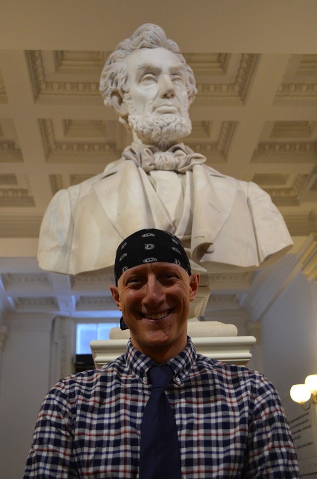 Ben Sarle stands in front of a statue of Abraham Lincoln at the Statehouse Tuesday. - PAUL HEINTZ