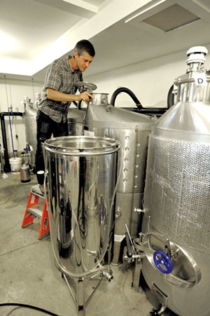 Checking the fermenting tanks - JEB WALLACE-BRODEUR