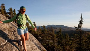 Emily Johnson navigates a large slab of granite high up in Vermont&#8217;s Worcester Mountain area.
