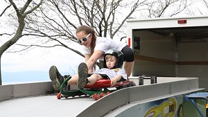 Evan Hausman with Junior National luger Gracie Weinberg of Middlebury at USA Luge Kids Day in Burlington