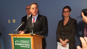 Gov. Peter Shumlin at a press conference, acting Health Commissioner Tracy Dolan at back