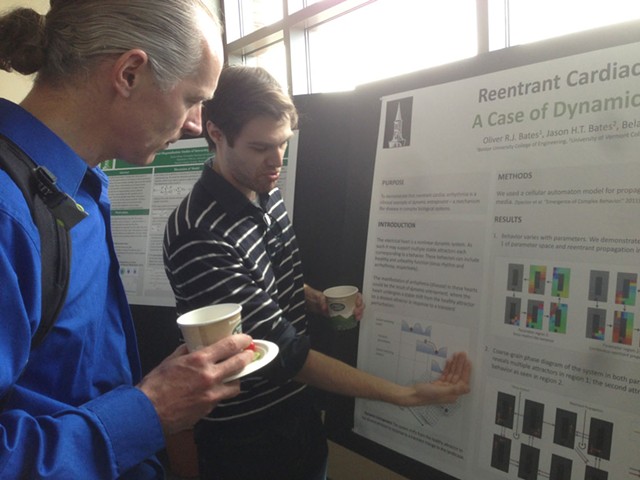 Grad student Oliver Bates explains his research to entrepreneur Uwe Heiss - COURTESY OF CATHY RESMER