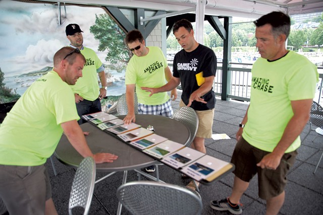 Jamie Polli (black shirt) looks at the Lake Champlain landmark challenge with Dealer.com employees - MATTHEW THORSEN