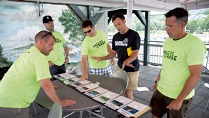 Jamie Polli (black shirt) looks at the Lake Champlain landmark challenge with Dealer.com employees