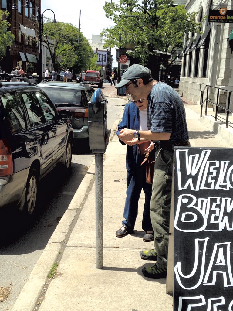Jon Kohn and his mother, Viola, feeding a meter on College Street - KEN PICARD