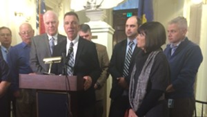 Lt. Gov. Phil Scott speaks as Republican lawmakers look on during a Statehouse press conference.