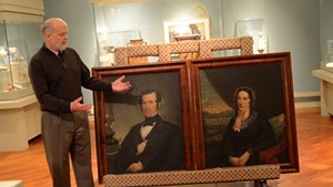 Museum director Richard Saunders unveils portraits of Henry Bliss and Electa Northup.