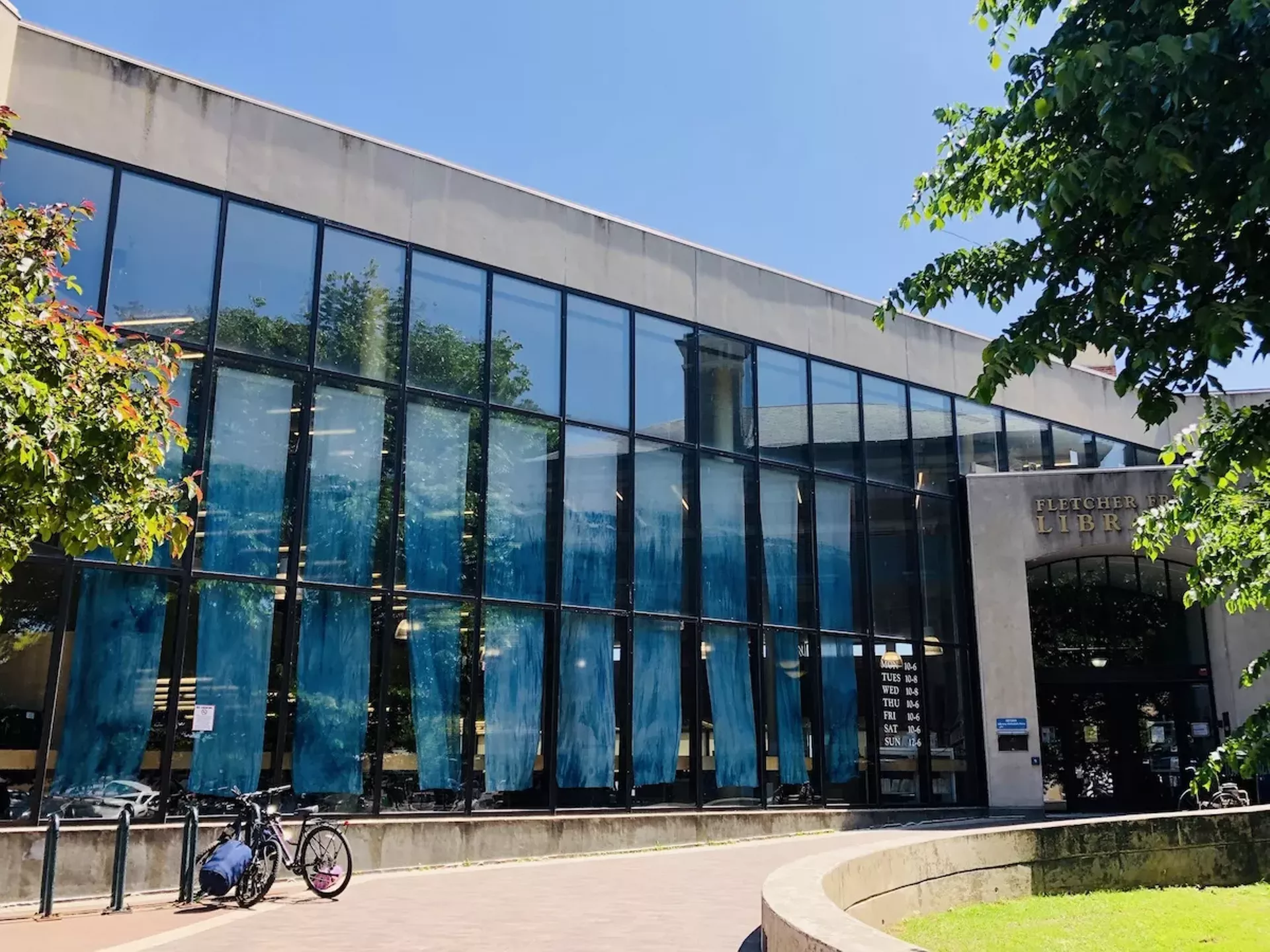 "Blue Alchemy" banners by Renee Greenlee in windows of Fletcher Free Library