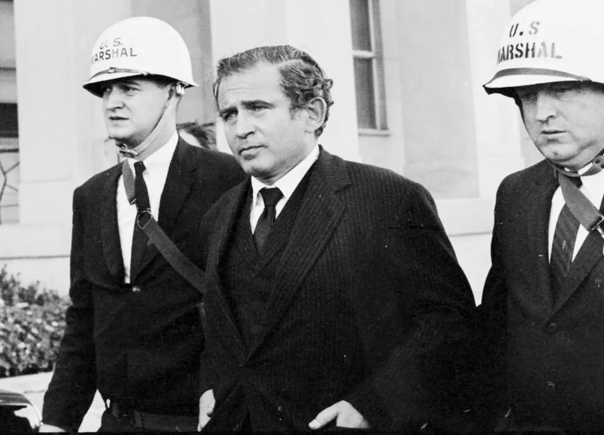 "Norman Mailer Flanked by Two U.S. Marshals" by Ross Connelly