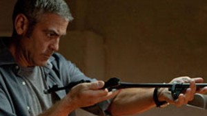 SOME ASSEMBLY REQUIRED Clooney&#8217;s line of work is ambiguous, but handcrafting instruments of death is clearly part of his job description.