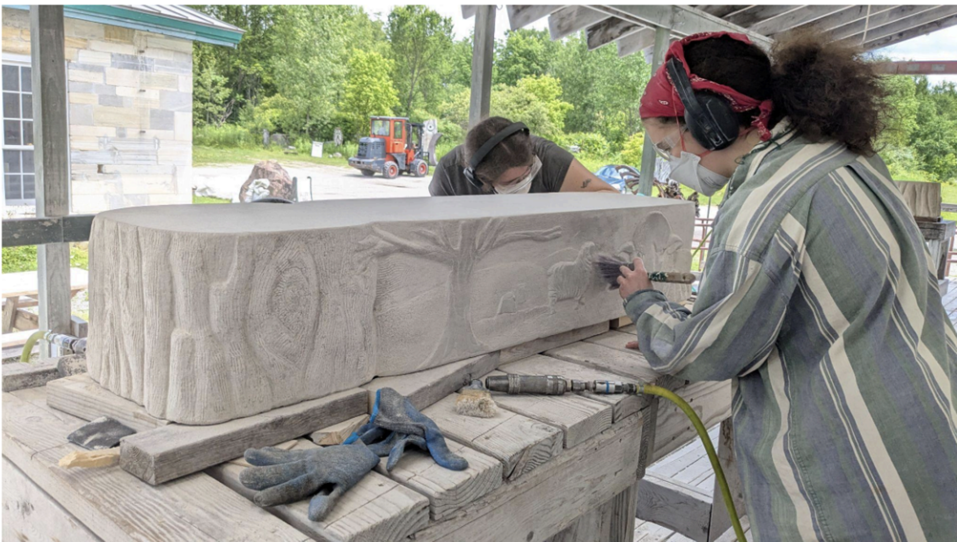Students carving the bench