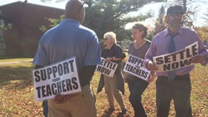 Teachers picket outside South Burlington High School Tuesday.