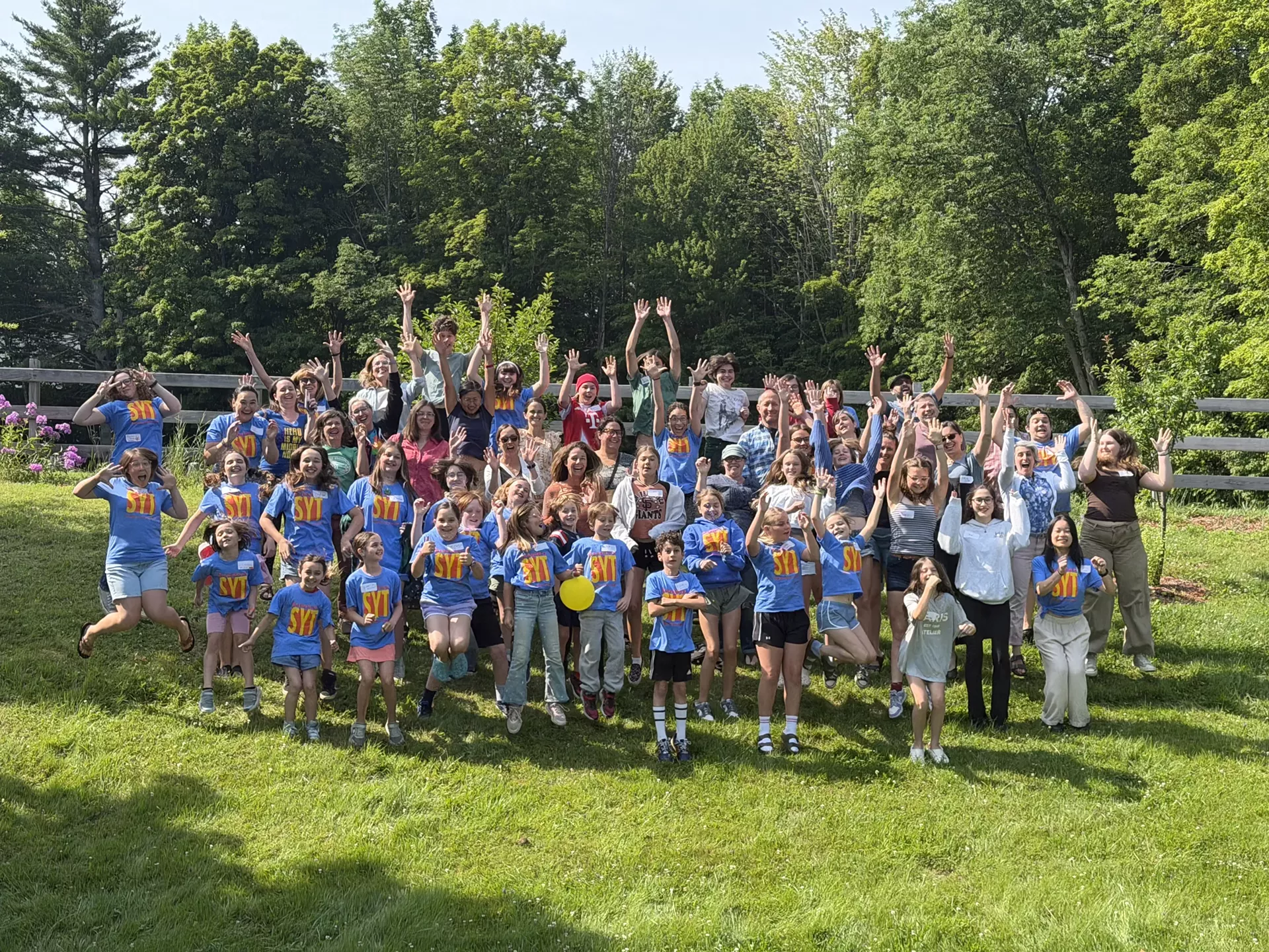 Campers, parents, and camp staff jump for joy on the first day of camp