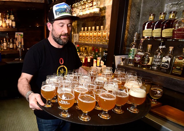 Ari Fishman delivering a tray of Zero Gravity beer - JEB WALLACE-BRODEUR