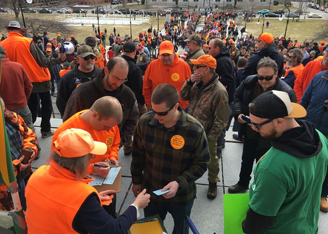 Gun-rights supporters making donations to the Federation of Vermont Sportsmen's Club for a lawsuit against S.55 while others wait in long lines to receive free 30-round magazines. - JOHN WALTERS