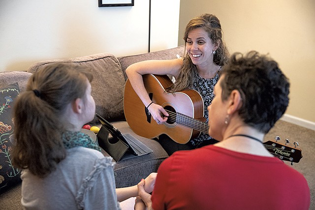 Marcie Hernandez (center) conducting a session with Hannah Waterman (left) as personal care assistant Stephanie Shohet helps out - JAMES BUCK