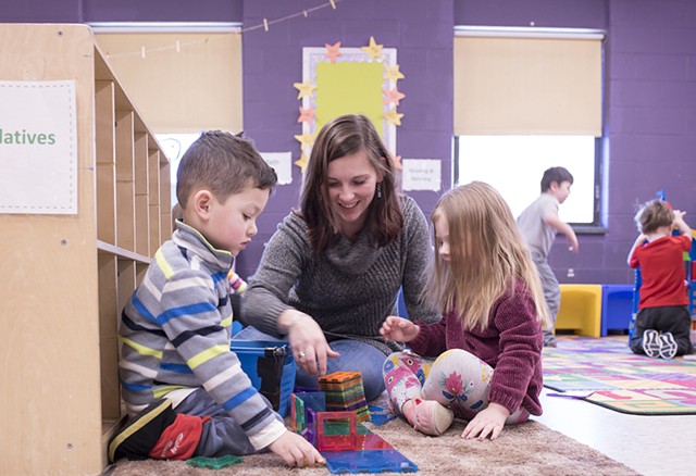Stephanie Carvey working with kids at Rekaroo's Childcare in Rutland, Vt. - CALEB KENNA