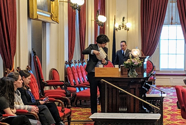 House Speaker Mitzi Johnson (D-South Hero) cleaned off her podium after accidentally smashing a glass lampshade with a gavel. - TAYLOR DOBBS