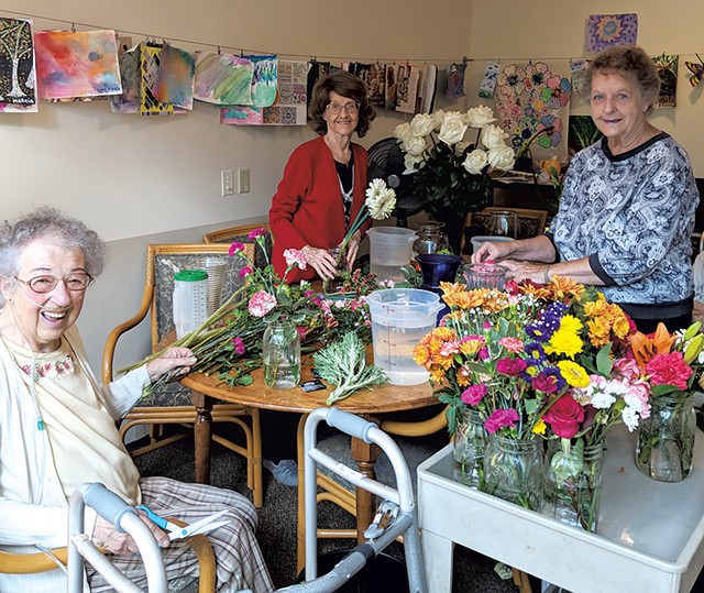 Residents arranging flowers from their garden - COURTESY OF THE LIVING WELL GROUP