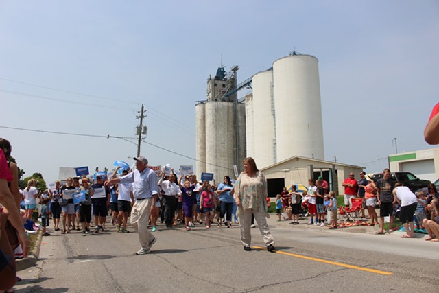 Sen. Bernie Sanders and Jane Sanders march in the Waukee, Iowa, Independence Day parade. - PAUL HEINTZ