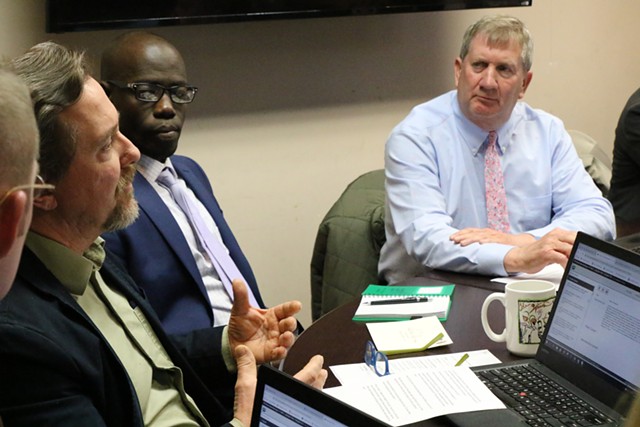 Councilor Brian Pine, left, speaks as councilors Ali Dieng, center, and Kurt Wright look on - COURTNEY LAMDIN