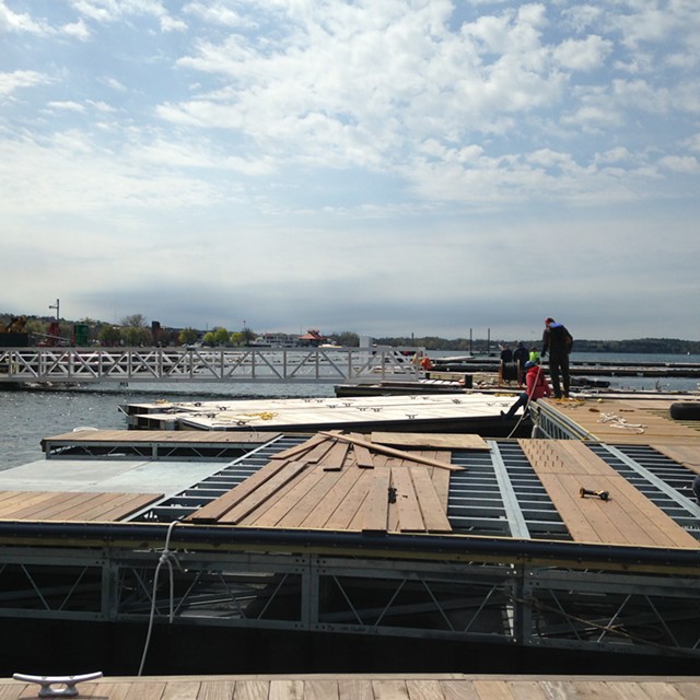 Workers assemble docks and slips at the Burlington Harbor Marina. - MOLLY WALSH