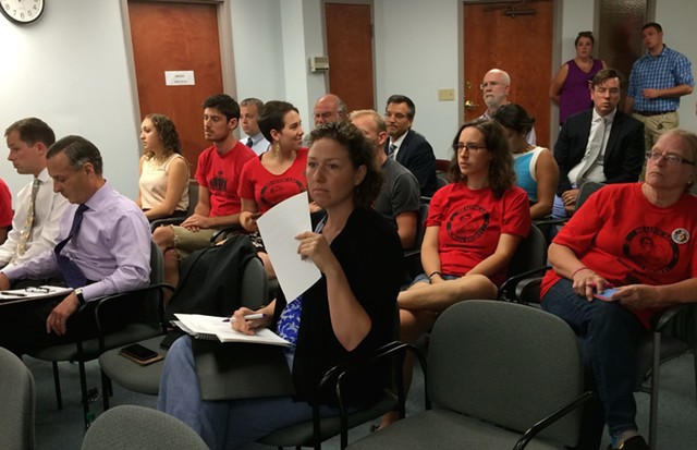 Some opponents of the requested insurance rate increase wore matching T-shirts to the hearing. - NANCY REMSEN