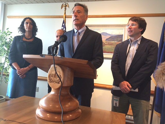 Gov. Peter Shumlin, flanked by Cassandra Gekas and Sean Sheehan, both with Vermont Health Connect, gave an update on its progress. - NANCY REMSEN