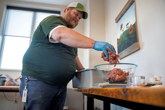 Adam Miller mixing bear meat and pork for meatballs and sausages - JAMES BUCK
