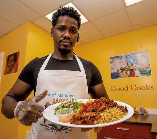 Chef Ahmed Omar with a classic Somali dish of rice and chicken - GLENN RUSSELL