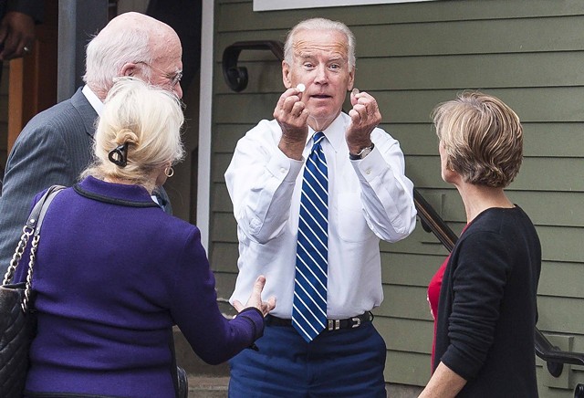 Then-vice president Joe Biden holding up coins he found outside Penny Cluse Café in October 2016 - POOL: GLENN RUSSELL/BURLINGTON FREE PRESS