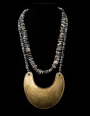 Original 1700s Hudson Bay Company gorgett and skunk bean necklace. These were given by the French to leaders during the French and Indian War, as a way for French troops to recognize status within a tribe. The French beads represented skunk beans that were worn by warriors in case they needed to make a soup in a hurry. - COURTESTY OF DIANE STEVENS