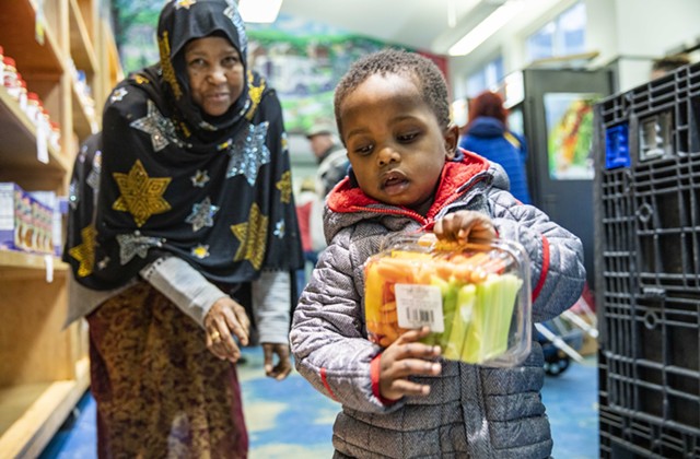 Nuna Ahmed and her grandson Mukhatar Kassim shop earlier this year at the Feeding Chittenden food pantry in Burlington. - COURTESY OF JUDE DOMSKI