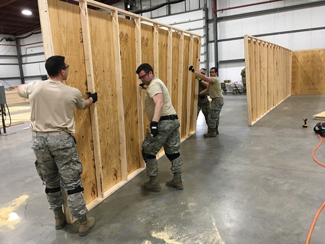 Vermont National Guard members erecting walls inside the exhibition hall - MATTHEW ROY