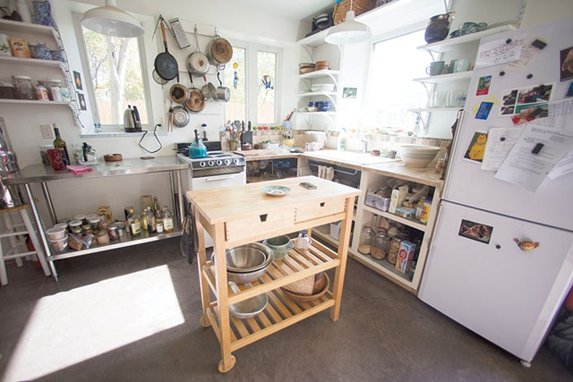 The kitchen has open shelving and a multipurpose island. - JAMES BUCK