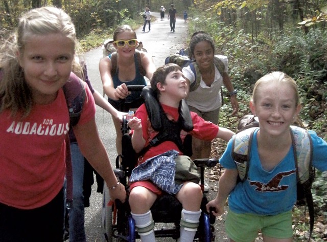Middle school classmates helping Ben Wood-Lewis climb Mount Philo back in 2011