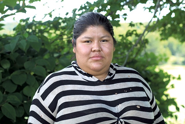 Pati, a migrant worker, on the northern Vermont farm on which she works - PAUL HEINTZ