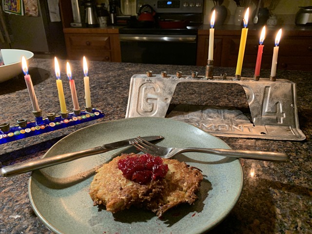 Latkes served on the third night of Hanukkah topped untraditionally with leftover Thanksgiving cranberry sauce. - MELISSA PASANEN ©️ SEVEN DAYS
