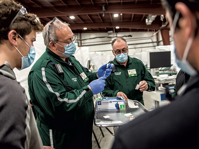 Preparing doses of the Pfizer COVID-19 vaccine at a University of Vermont Health Network vaccination clinic at the Champlain Valley Exposition - COURTESY OF UVM MEDICAL CENTER/RYAN MERCER