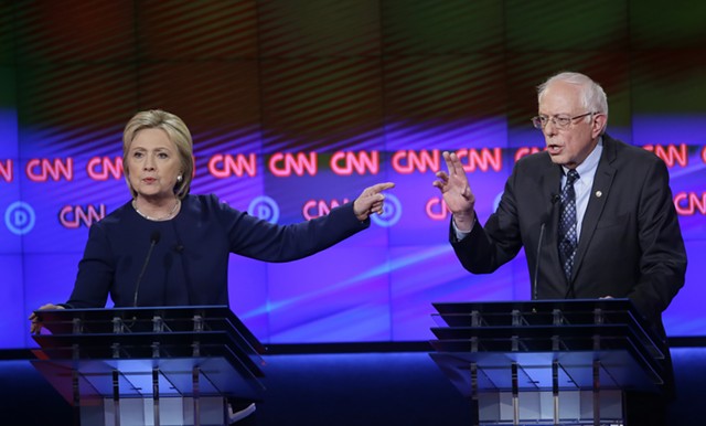 Hillary Clinton and Sen. Bernie Sanders debate Sunday night in Flint, Michigan. - AP PHOTO/CARLOS OSORIO