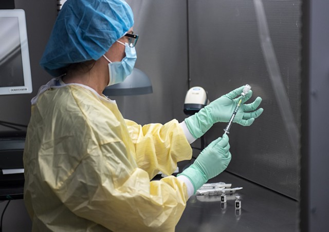 A health care worker prepares a dose of COVID-19 vaccine - COURTESY OF RYAN MERCER / UVM MEDICAL CENTER