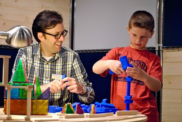 Marcos Stafne engaging in hands-on science with young patron - MONTSHIRE MUSEUM OF SCIENCE