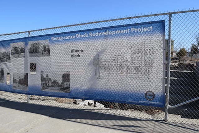 A sign touting the Renaissance Block project covers a fence on Main Street in Newport. - TERRI HALLENBECK