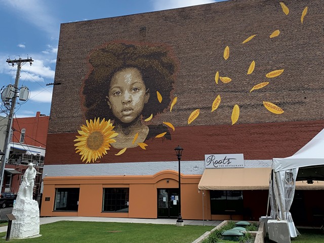 "We Who Believe in Freedom Cannot Rest Until It Comes" mural by LMNOPI at Center Street Marketplace Park - SOPHIE X. POLLAK