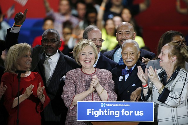 Flanked by supporters, including former New York Mayor David Dinkins, Democratic presidential candidate Hillary Clinton celebrates after winning the New York primary election. - AP PHOTO/KATHY WILLENS