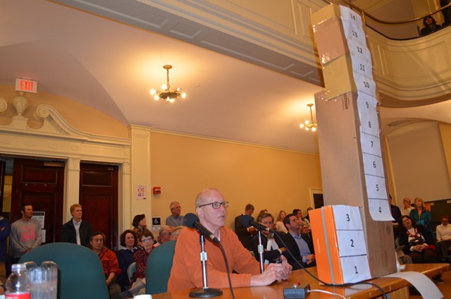 Resident Jay Vos brought a cardboard model to the council meeting to show the scale of the proposed Burlington Town Center project.