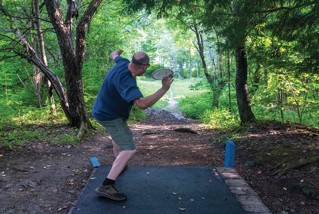 A disc golfer at Center Chains in Waterbury Center - JEB WALLACE-BRODEUR