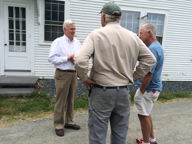 David Hall, left, chats with Bill Emmons, center, after meeting with members of the Two Rivers-Ottauquechee Regional Commission. - ALICIA FREESE